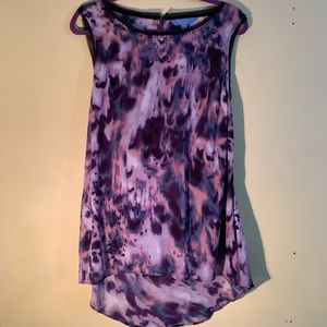 Tunic length tank with sheer detail along hem.